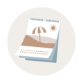 Ein illustrierter Tischkalender zeigt einen Strand mit Sonne und einem Sonnenschirm